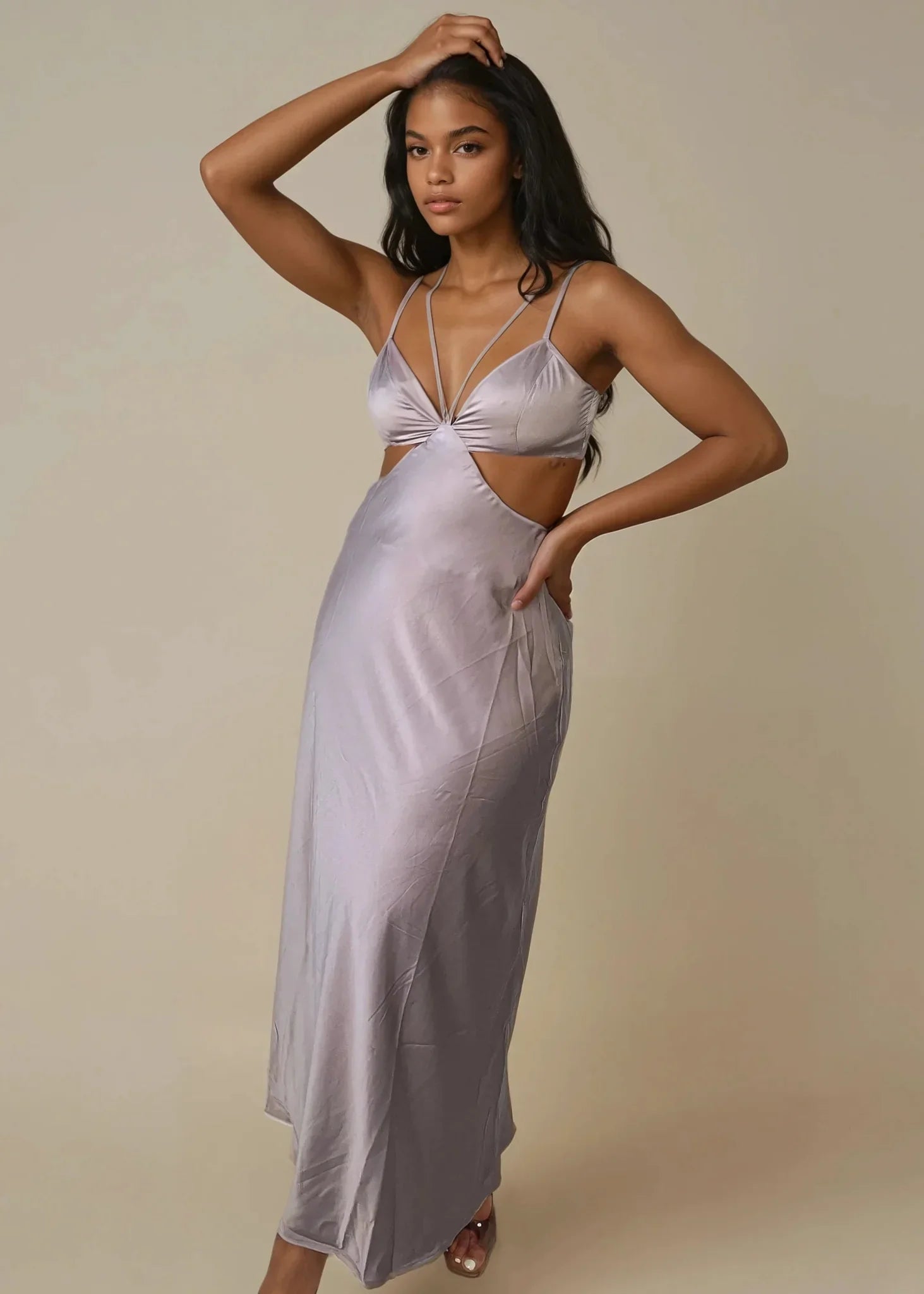 Woman wearing mocha satin cut-out maxi dress with spaghetti straps and side cutout detail